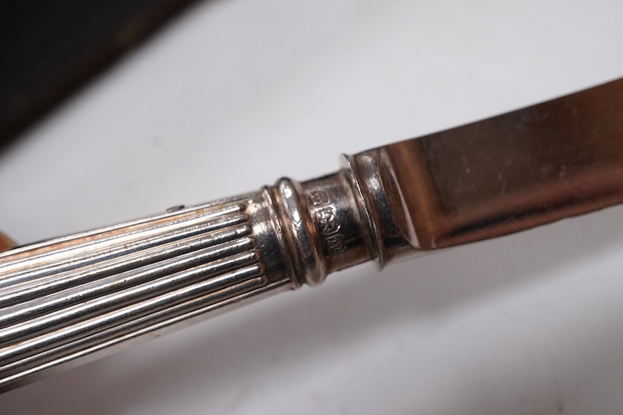 A cased set of six pairs of silver pistol handled dessert eaters, by James Dixon & Sons Ltd, Sheffield, 1905, knife 16.6cm.